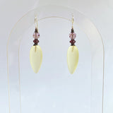 Frosted yellow glass earrings. Focal beads are light amethyst Austrian crystal with deep purple Czech glass accents. Sterling silver ear wires. All handwork done in the USA.