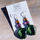 Green glass earrings with colorful beads on a 'OGC' branded card.