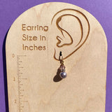 Light amethyst pearl coated crystal earrings. Austrian crystal top beads, gold accents.
