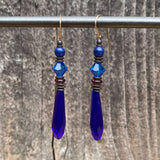 Cobalt blue chandelier earrings. German and Czech glass with Austrian crystal. Metal trim is antiqued bronze with 14-karat gold-filled ear wires. All handwork done in the USA.