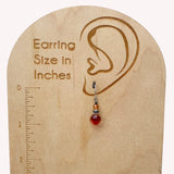 Wooden earring size chart with an ear illustration and a hanging earring.