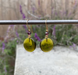 Bright olive green glass earrings. Top beads are amethyst Austrian crystal. Ear wires are 14 karat gold-filled. All handwork done in the USA.
