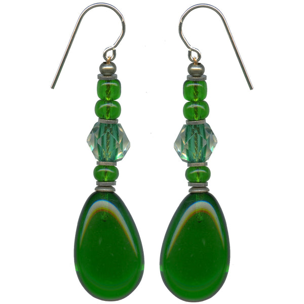 Emerald green glass drop earrings with antique Japanese focal beads. Antiqued silver overlay metal trim with sterling silver ear wires. All handwork done in the USA.