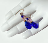 Cobalt glass drops with light pink Austrian crystal focal beads. Top beads are cobalt Czechoslovakian glass. Metal trim is 14 karat gold overlay. Ear wires are 14 karat gold filled. All handwork done in the USA.