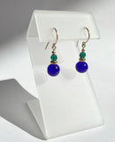 Cobalt glass drop earrings with emerald Austrian crystal top beads. Ear wires are 14 karat gold filled. All handwork done in the USA.