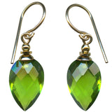 Bright green faceted glass earrings with gold trim.