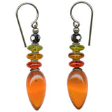 A pair of Allen Owen Tango 8 earrings featuring bright orange glass drops with topaz and olivine accents, and hematite Austrian crystal top beads, suspended from silver ear wires.