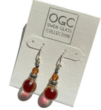 Orange glass and crystal earrings on a hang tag.