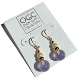 Light amethyst glass drop earrings with glass pearl top beads. Trim is gold overlay with 14 karat gold filled ear wires. All handwork done in the USA.