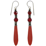 Pair of earrings with red prisms and bronze accents on a white background