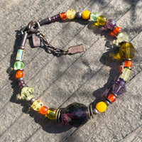 Glass and crystal beaded bracelet in amethyst and yellow.