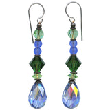 Pair of earrings with green and blue beads on a white background