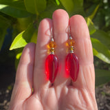 Bright red glass earrings with green and topaz accents in Czech glass and Austrian crystal. Ear wires are sterling silver. Handmade in the USA.