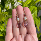 Mauve glass earrings with crystal pearls and gold trim.