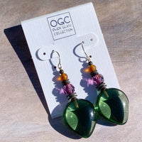 Green glass earrings with colorful beads on a 'OGC' branded card.