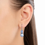 Blue pearl and crystal earrings on a model.