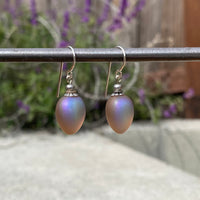 Frosted taupe earrings with iridescent sheen.