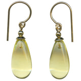 Yellow glass earrings with gold trim.