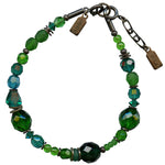 Green beaded bracelet with metal accents on a white background