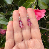 Pink crystal earrings with silver wires.