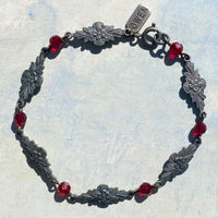 Red crystal bracelet with antiqued silver dipped filigree.
