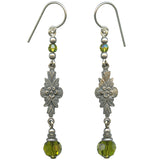 Pair of silver earrings with floral designs and green beads on a white background