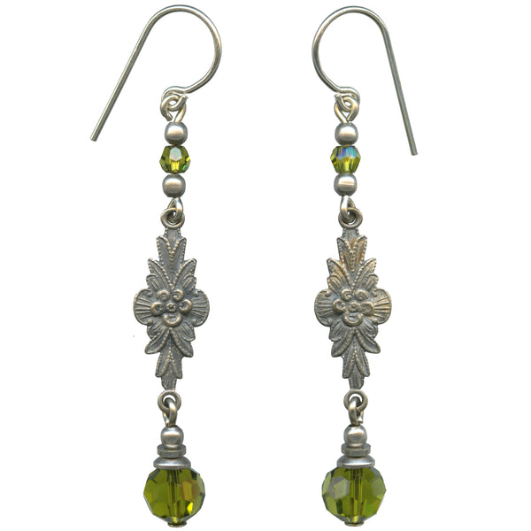 Pair of silver earrings with floral designs and green beads on a white background