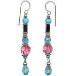 Pair of beaded earrings with blue, pink, and black beads on a white background