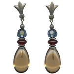 Pair of earrings with teardrop-shaped beads and blue and red accents on a white background