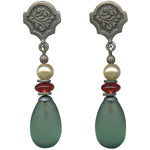 Pair of earrings with green teardrop beads and red and white beads on a white background
