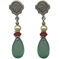Pair of earrings with green teardrop beads and red and white beads on a white background