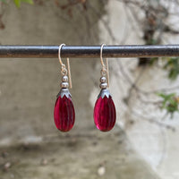 Dark rose glass earrings.