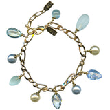 Gold bracelet with blue and white beads on a white background