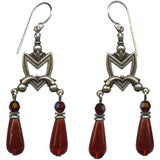 Pair of silver earrings with red teardrop-shaped beads on a white background