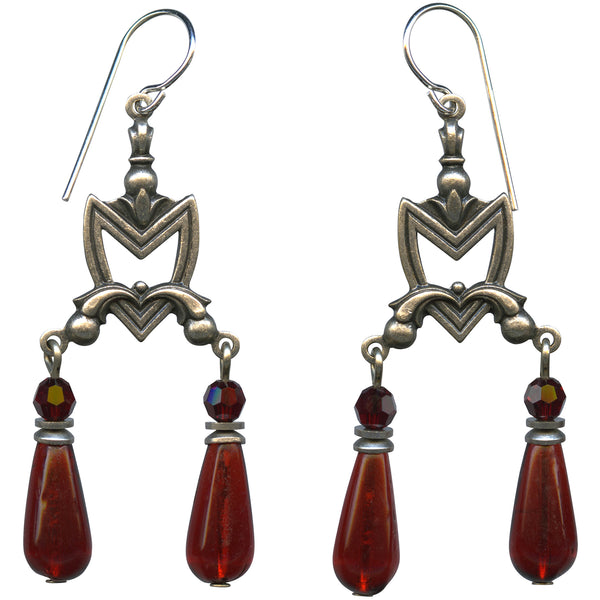 Pair of silver earrings with red teardrop-shaped beads on a white background