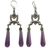 Pair of silver earrings with purple teardrop-shaped beads on a white background