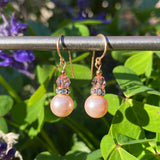 Light pink earrings. Austrian crystal drops in pink. Top beads are light pink Austrian crystal. Gold trim, rhinestone accents. Ear wires are 14-karat gold-filled. All handwork done in the USA.