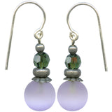 Pair of earrings with green beads and purple stones on a white background