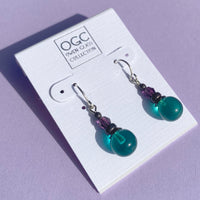 Teal German glass drop earrings. Top beads are amethyst Austrian crystal.