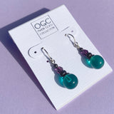 Teal German glass drop earrings. Top beads are amethyst Austrian crystal.