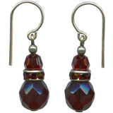 Pair of earrings with red faceted beads and silver accents on a white background