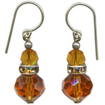 Pair of amber-colored beaded earrings with silver hooks on a white background