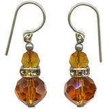 Pair of amber-colored beaded earrings with silver hooks on a white background