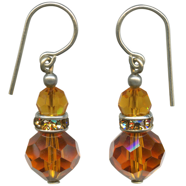 Pair of amber-colored beaded earrings with silver hooks on a white background