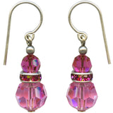 Pink beaded earrings with silver hooks on a white background