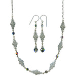 Silver necklace and earrings set with floral designs and colorful beads on a white background
