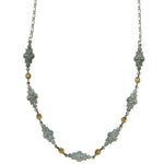 Decorative necklace with floral designs and gold accents on a white background