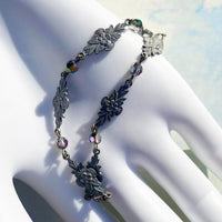 Filigree bracelet with iridescent crystal accents.