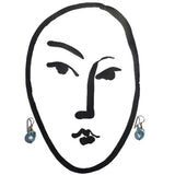 Light aqua earring with gold trim.