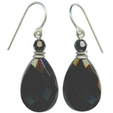 A pair of teardrop-shaped black faceted drop earrings with small black beads and silver French hook wires, shown against a plain white background.